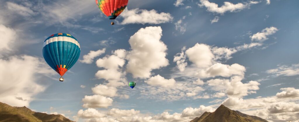 hot air balloons flying in blue sky with white fully clouds