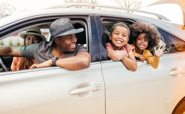 Family looking out of car windows